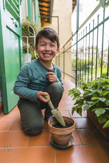 Portrait of little boy pulling funny face on balcony
