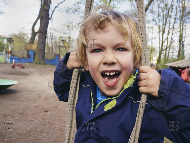 Portrait of screaming little boy on playground