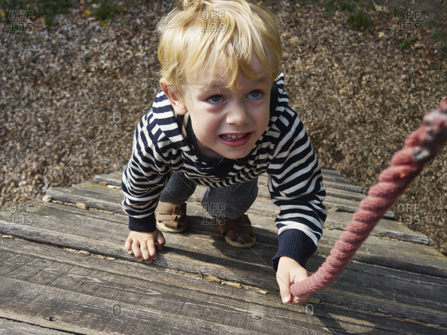 Portrait of little boy on climbing frame