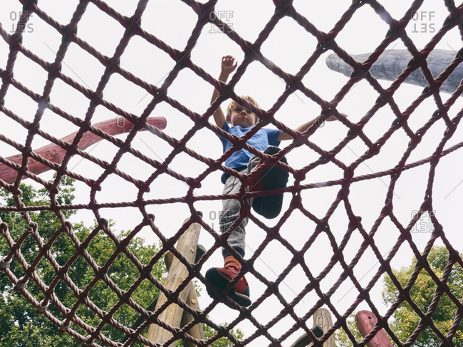 Little boy walking on Jungle gym