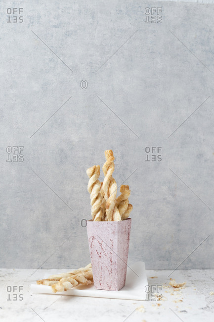 Paperbag of puff pastry sticks with sugar and cinnamon