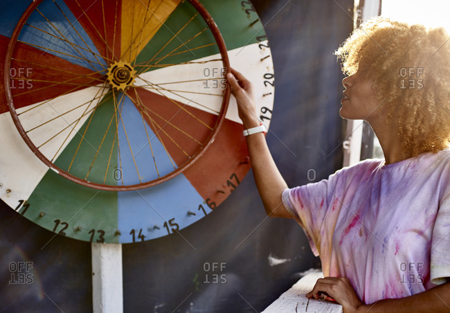Woman turning wheel of fortune