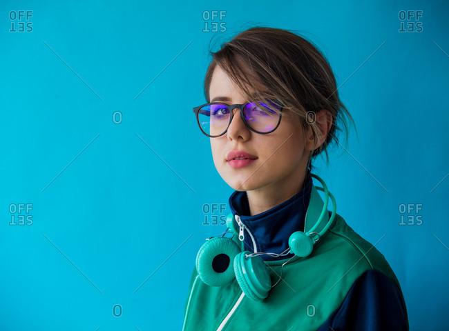 Young female hipster looking away while using mobile phone against