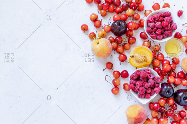 Various fresh fruits and berries with copy space