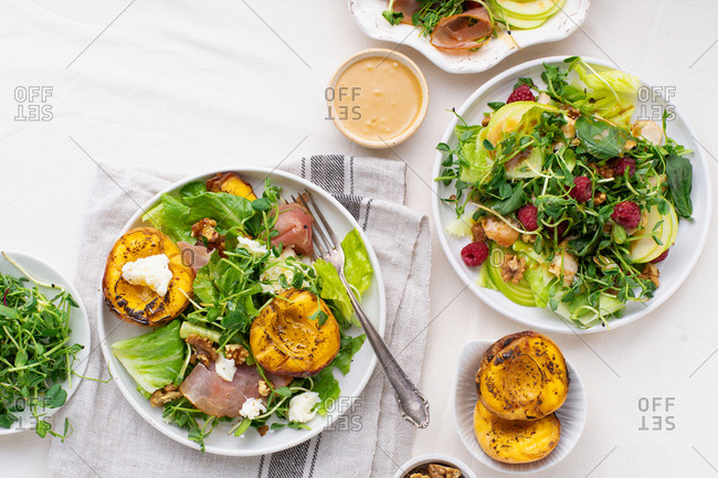 Overhead view of a variety of summer salads and dressings