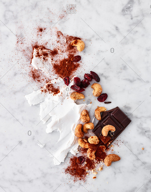 Stylized food including E Guittardchocolate flat lay with mixed ingredients displayed on marble countertop.