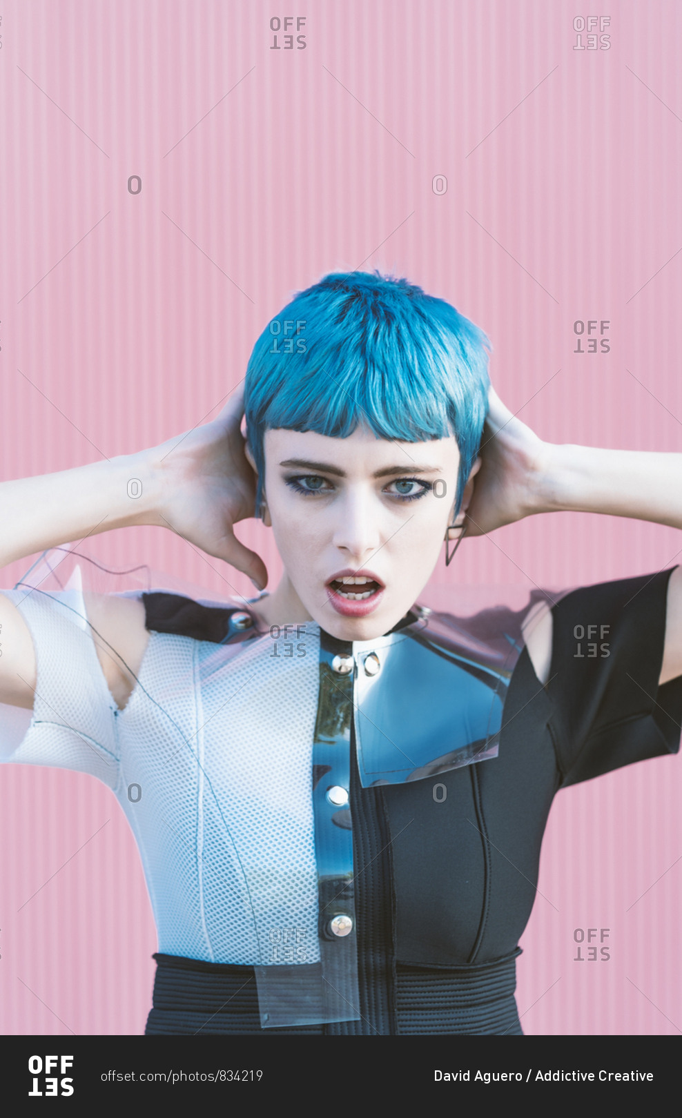 Young Woman In Trendy Alternative Dress Touching Short Blue Hair