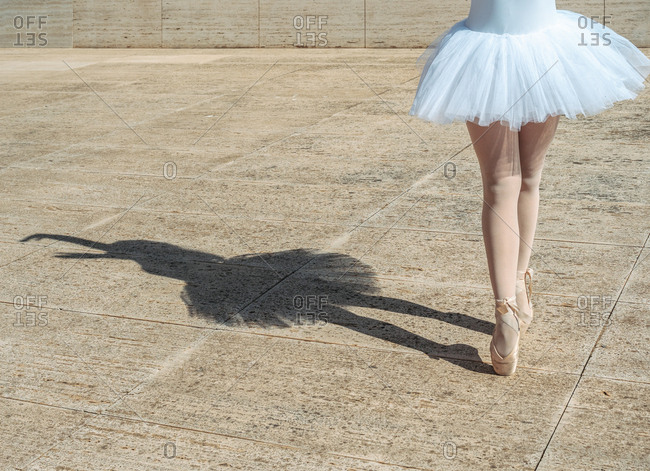 Ballerina standing on tiptoe classical position outside