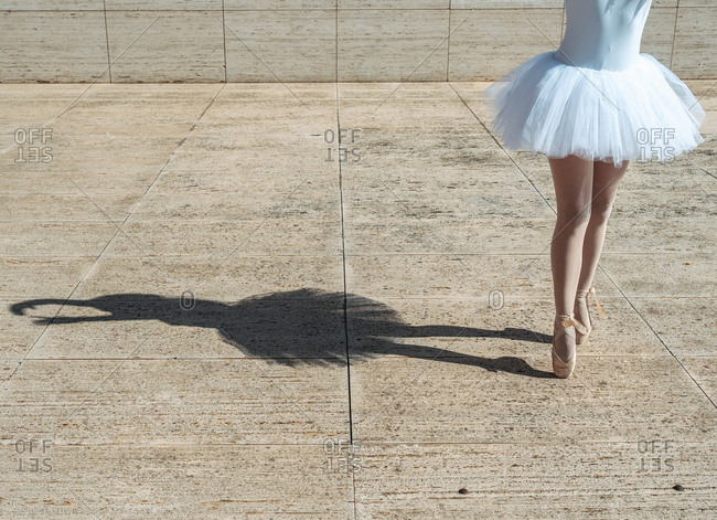 Ballerina standing on tiptoe classical position outside
