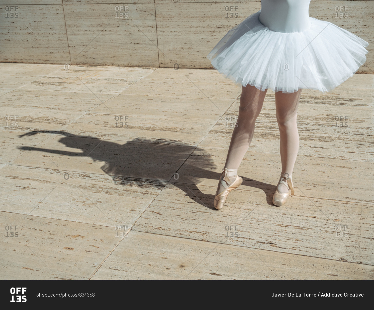 Ballerina standing on tiptoe classical position outside