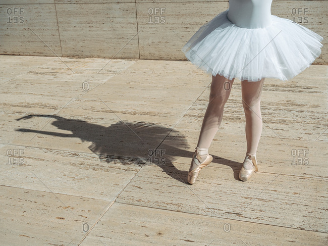 Ballerina standing on tiptoe classical position outside