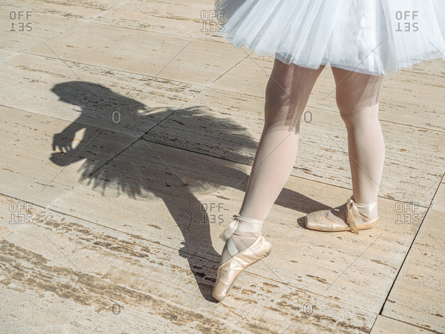 Ballerina standing on tiptoe classical position outside