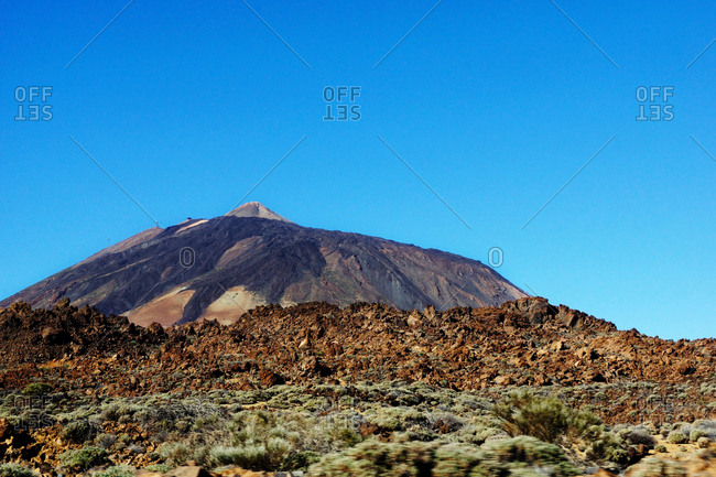 Volcano of Teide and burnt wild area of Tenerife, Spain on background of clear blue sky