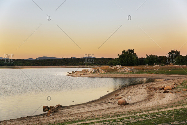 Picturesque view of lake with countryside route, fir forest and hills in Valmayor Lake Spain