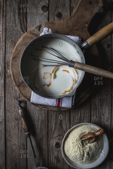 From above baking dish with corn flour for cooking on cutting board on wooden background