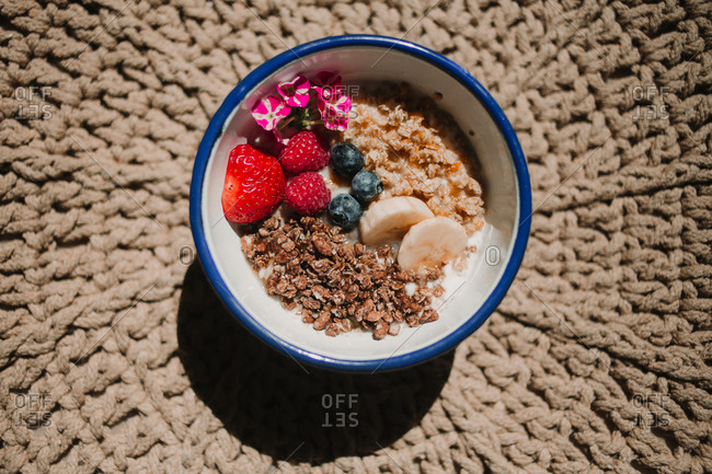 From above appetizing tasty fresh strawberry blueberry banana cereals in bowl