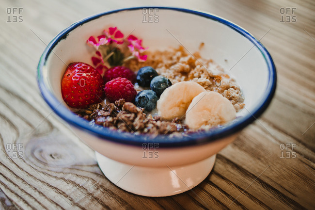 From above appetizing tasty fresh strawberry blueberry banana cereals in bowl