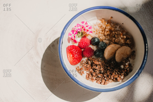 From above appetizing tasty fresh strawberry blueberry banana cereals in bowl