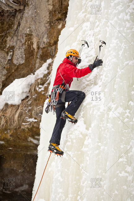 A man is climbing a frozen waterfall in Sounkyo Gorge, Daisetsuzan National Park, Hokkaido, Japan