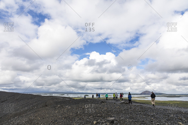 Visitors hiking crater rim of volcano Hverfjall (Hverfell), Iceland