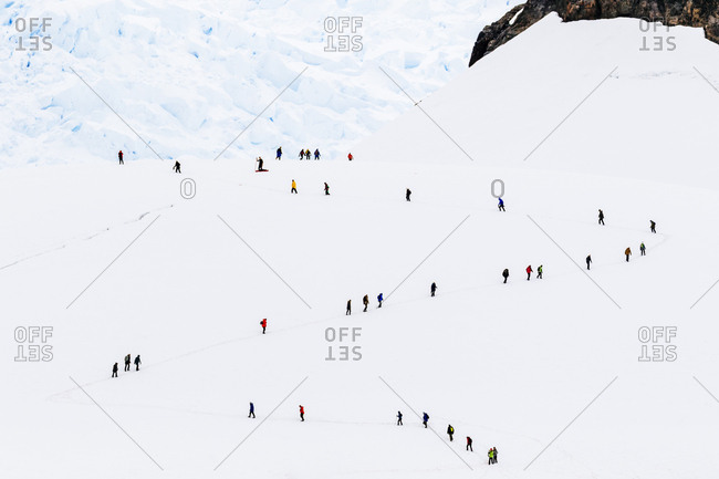 Hikers on mountainside, Paradise Harbor, Antarctica