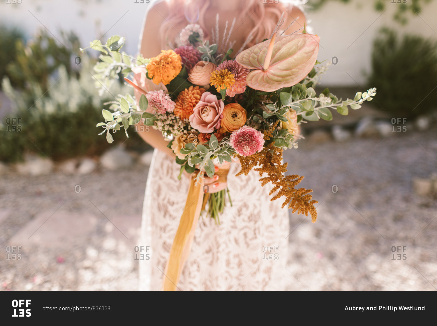 Bride holding colorful pink and orange bouquet