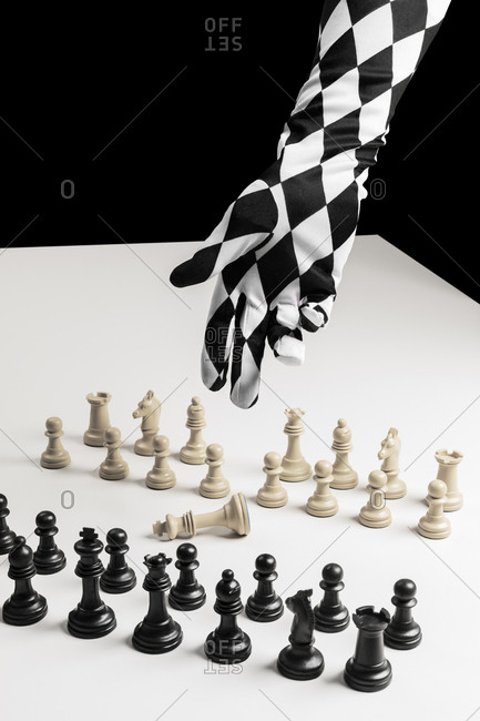Chess figures and hand with glove chess board
