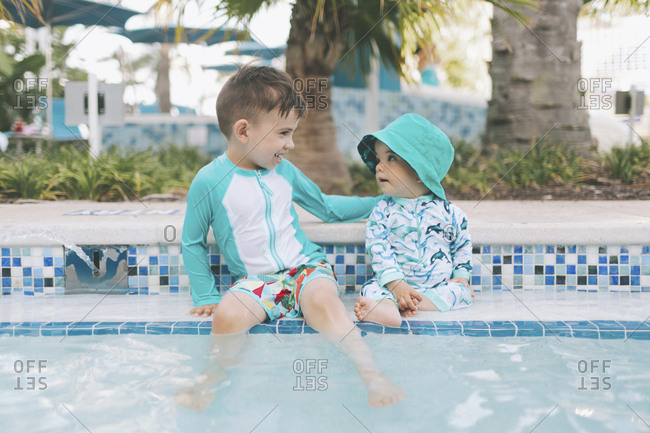 Happy little brothers at a swimming pool