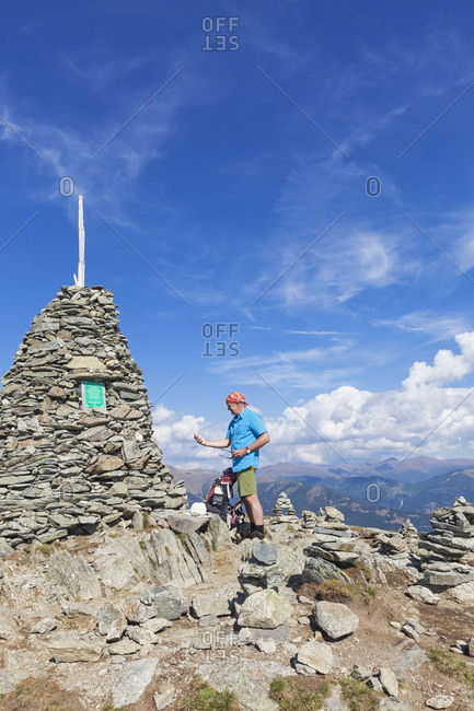 Hiker at viewpoint with cairn- Lammersdorf Mountain- Nock Mountains- Carinthia- Austria