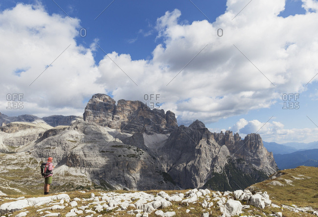 Hiker on hiking trail- Tre Cime di Lavaredo Aera- Nature Park Tre Cime- Unesco World Heritage Natural Site- Sexten Dolomites- Italy