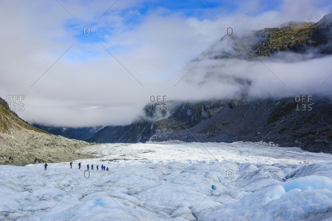 Tourists hiking on Fox Glacier- South Island- New Zealand