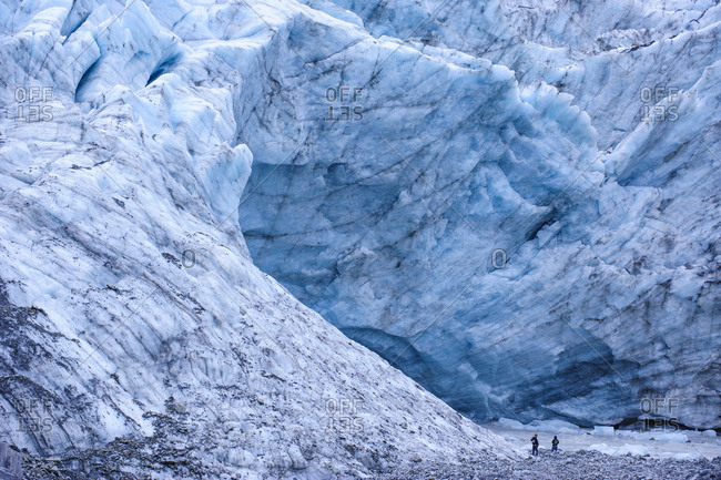 Tourists hiking to the giant glacial outflow of Fox Glacier- South Island- New Zealand