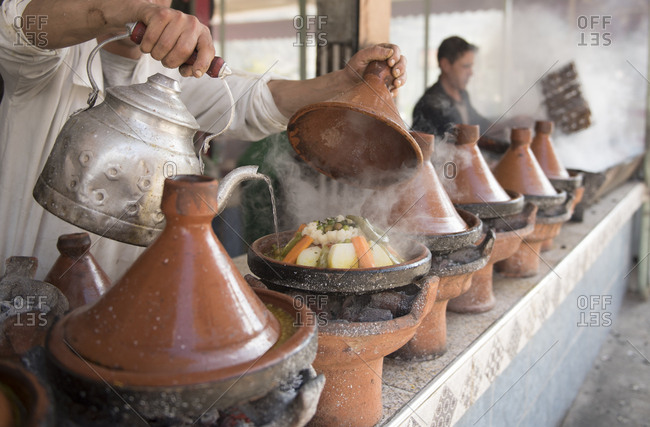 People cooking Moroccan tagine, Marrakesh, Morocco