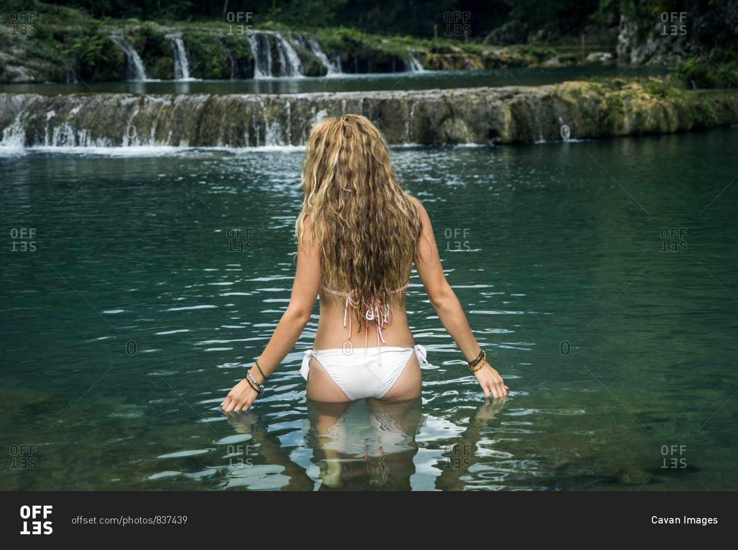 Woman in bikini in waters of Semuc Champey, Guatemala stock photo OFFSET