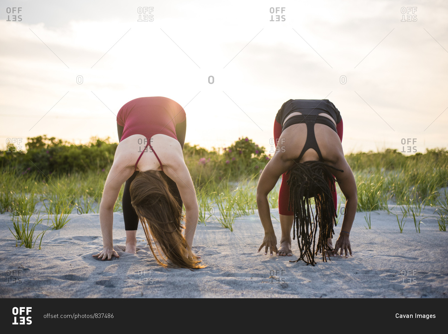 Women doing yoga in Forward Fold Pose (Uttanasana), Newport, Rhode Island, USA