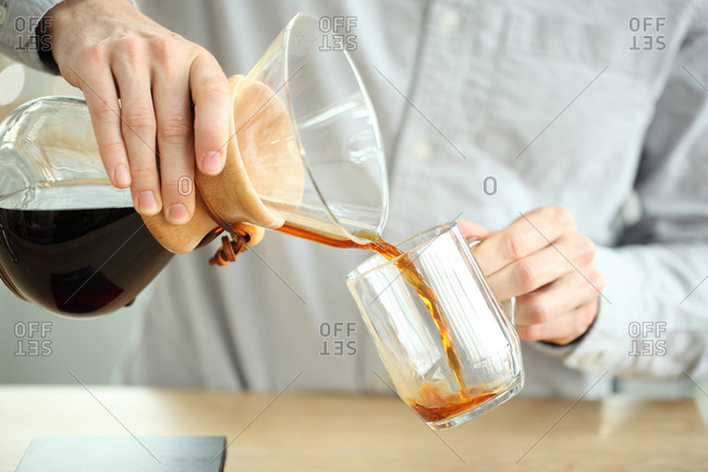 Barista pouring coffee into mug, Oakland, California, USA