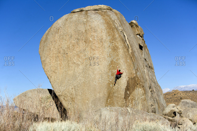 Male lead climbing on a boulder
