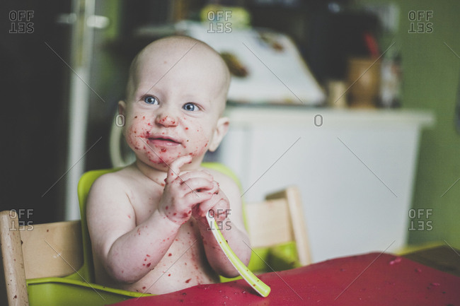 Baby boy making mess while eating