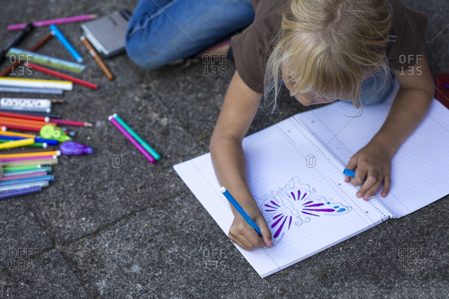 Girl crouching on pavement painting