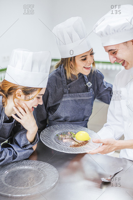 Junior chef showing his prepared dessert on plate