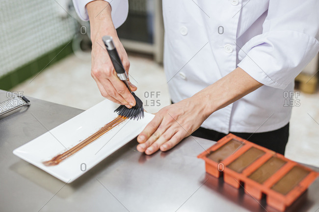 Junior chef preparing a dessert on plate