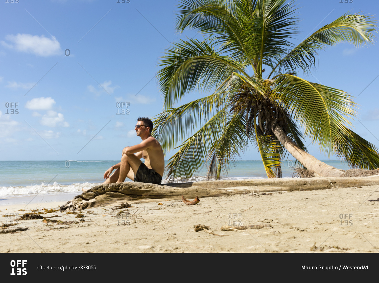 Man sitting on a tropical beach- Cahuita National Park- Costa Rica