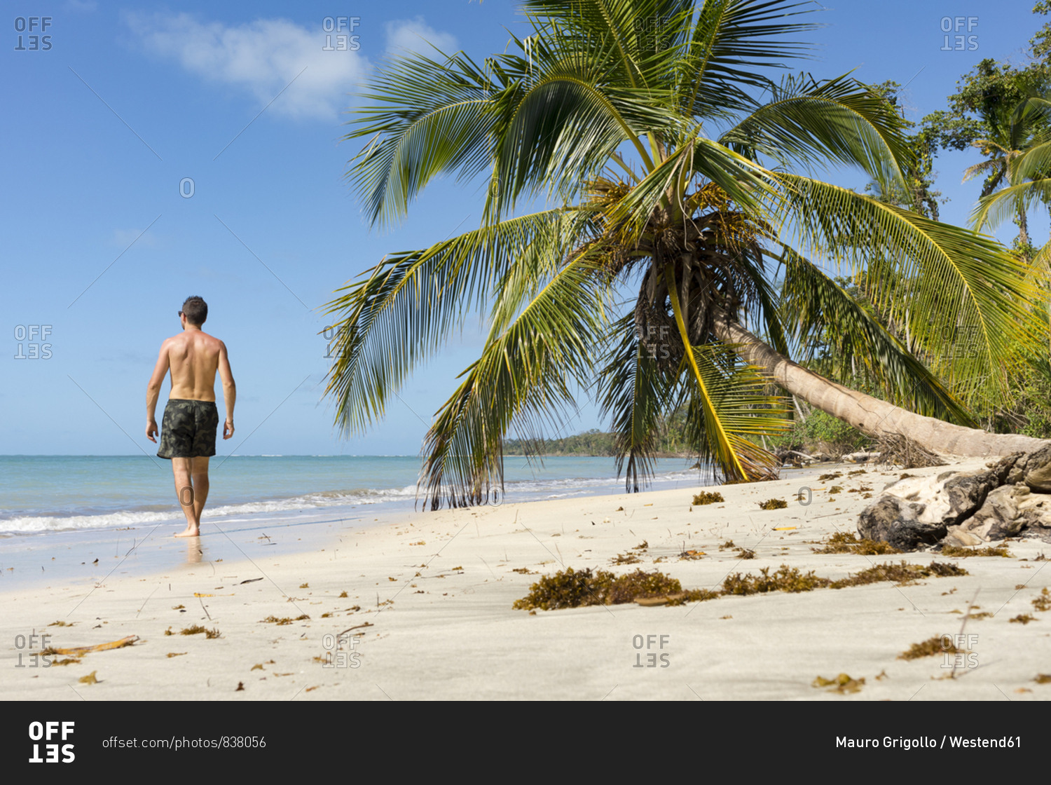 Man walking along a tropical beach- Cahuita National Park- Costa Rica