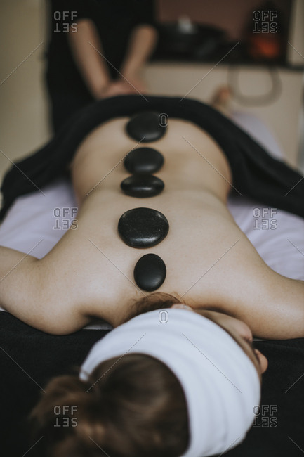 Woman laying on stomach enjoying a spa treatment on her back