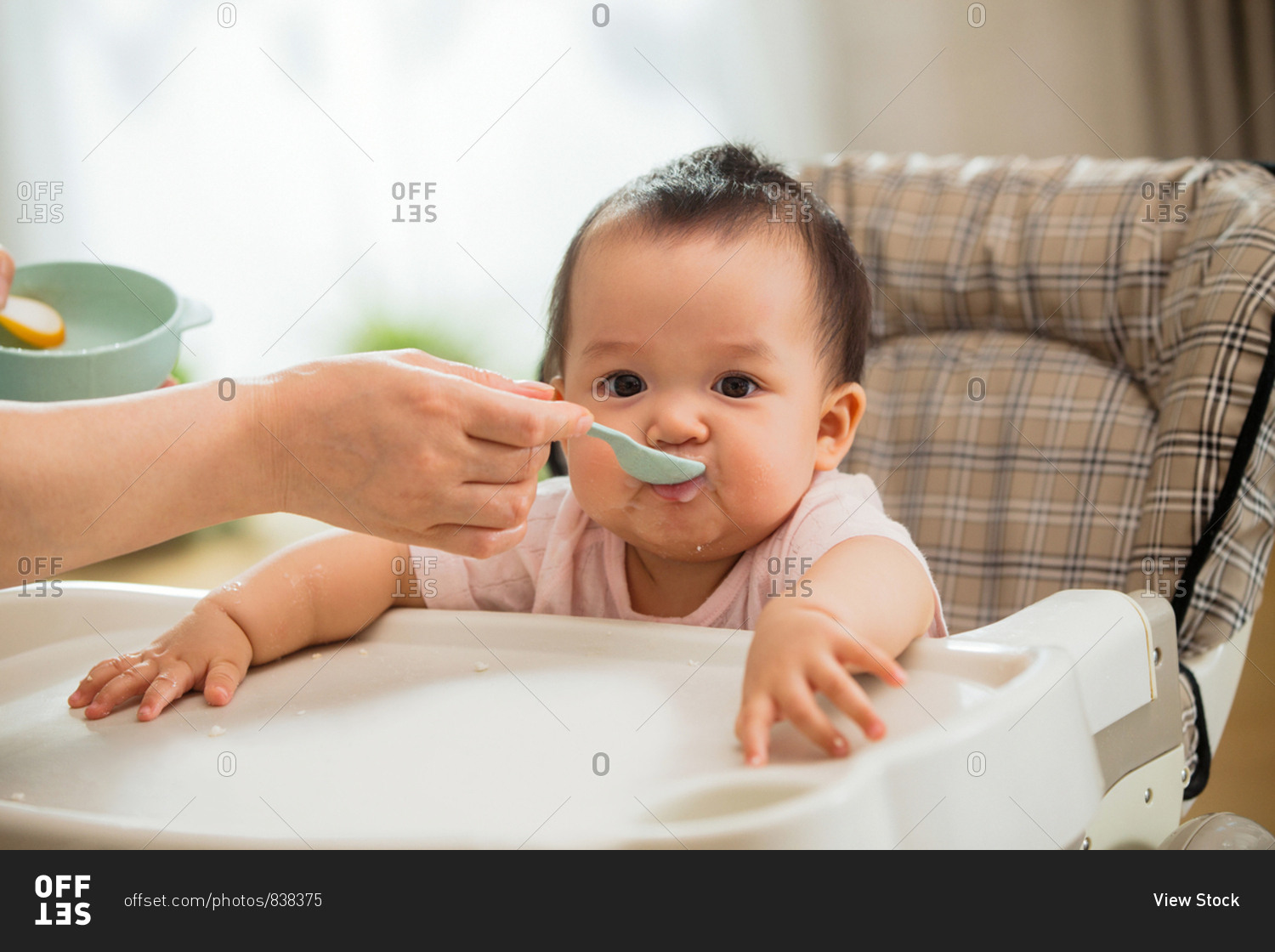 Mother to feed the baby rice stock photo OFFSET