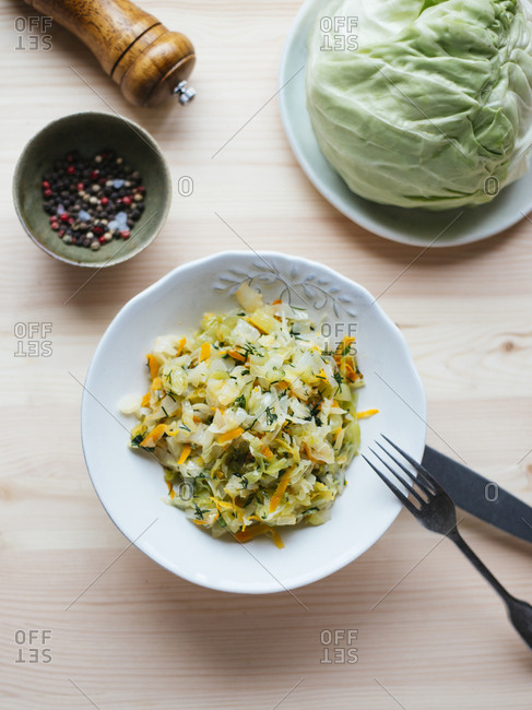 Cabbage stewed with carrot, white onion and dill