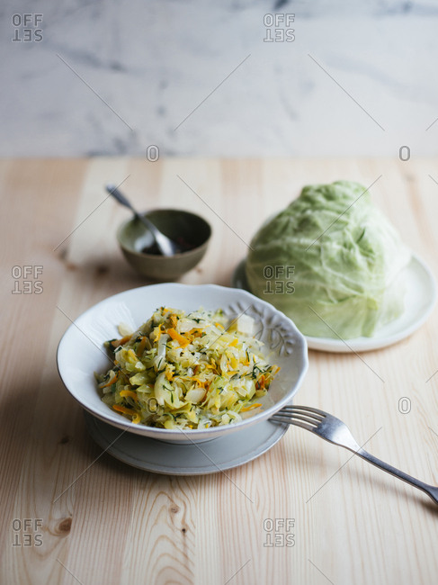 Cabbage stewed with carrot, white onion and dill