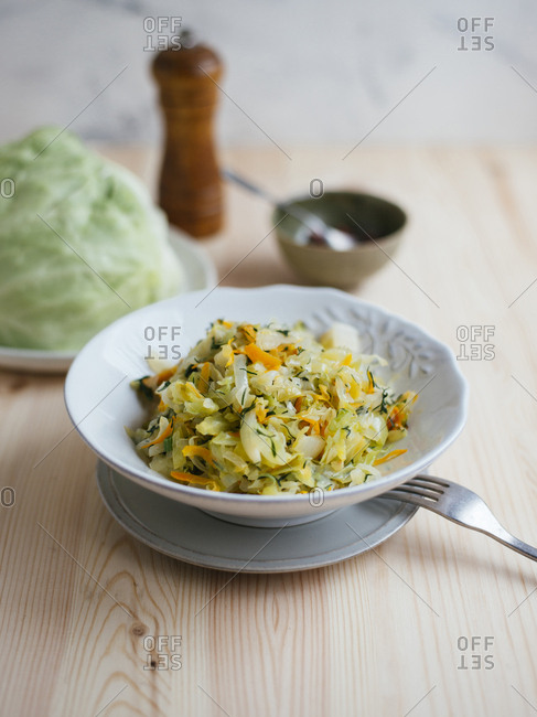 Cabbage stewed with carrot, white onion and dill