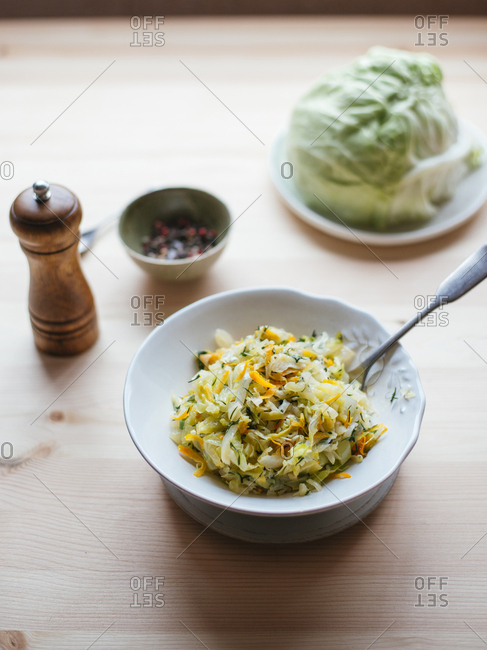 Cabbage stewed with carrot, white onion and dill