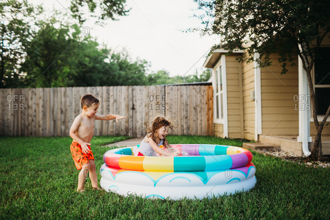 Kids Splashing In Colorful Inflatable Pool Stock Photo Offset